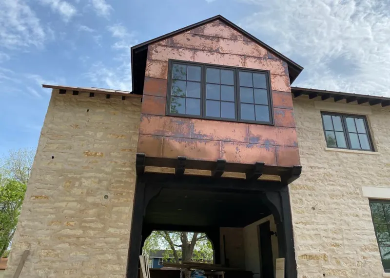 Copper metal panel facade on a stone building for Roof Repair in East Windsor